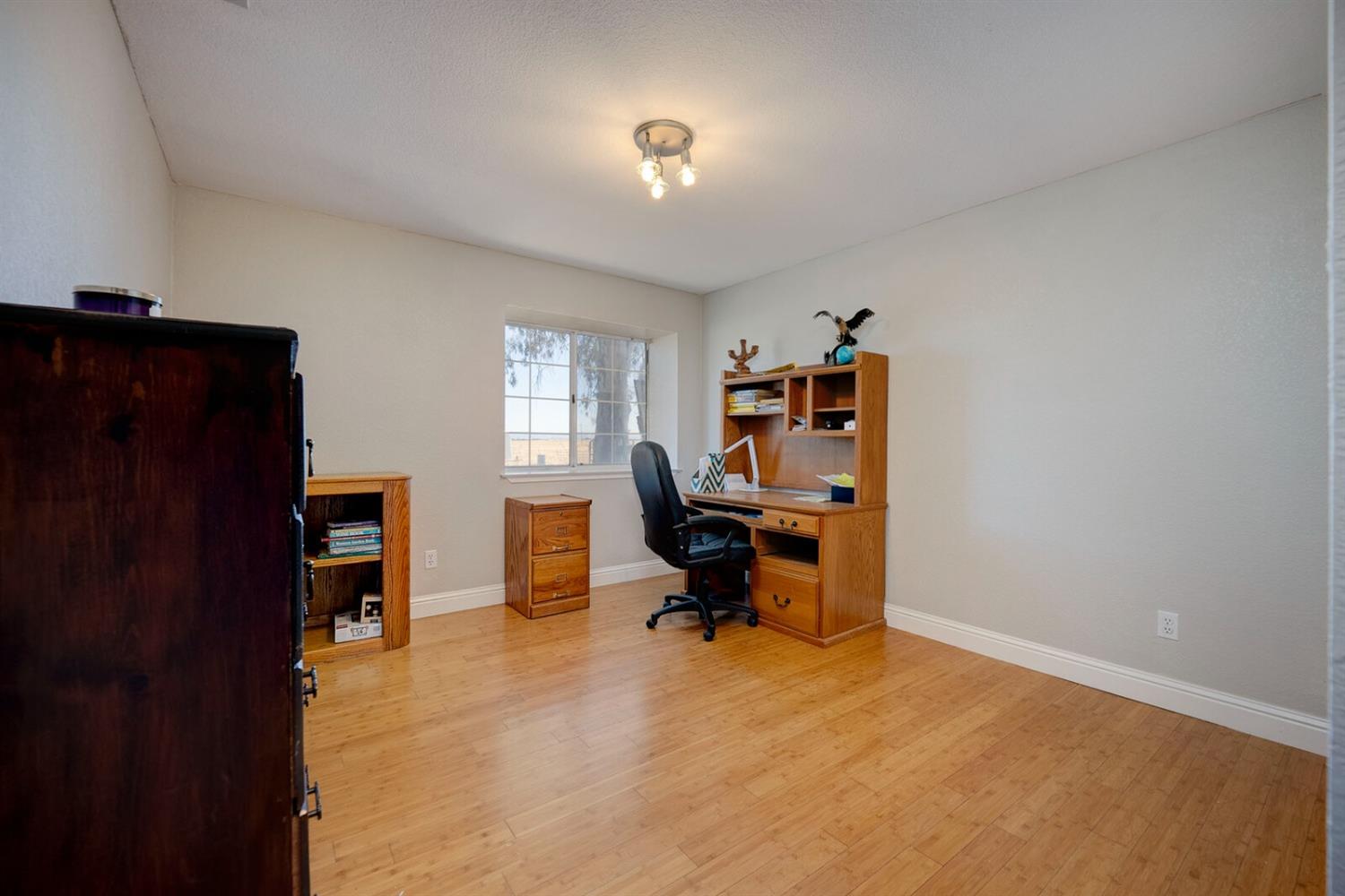 4427 East Catlett Road Lincoln, CA 95648 - Photo 28 of 51 a view of a workspace with furniture and a window