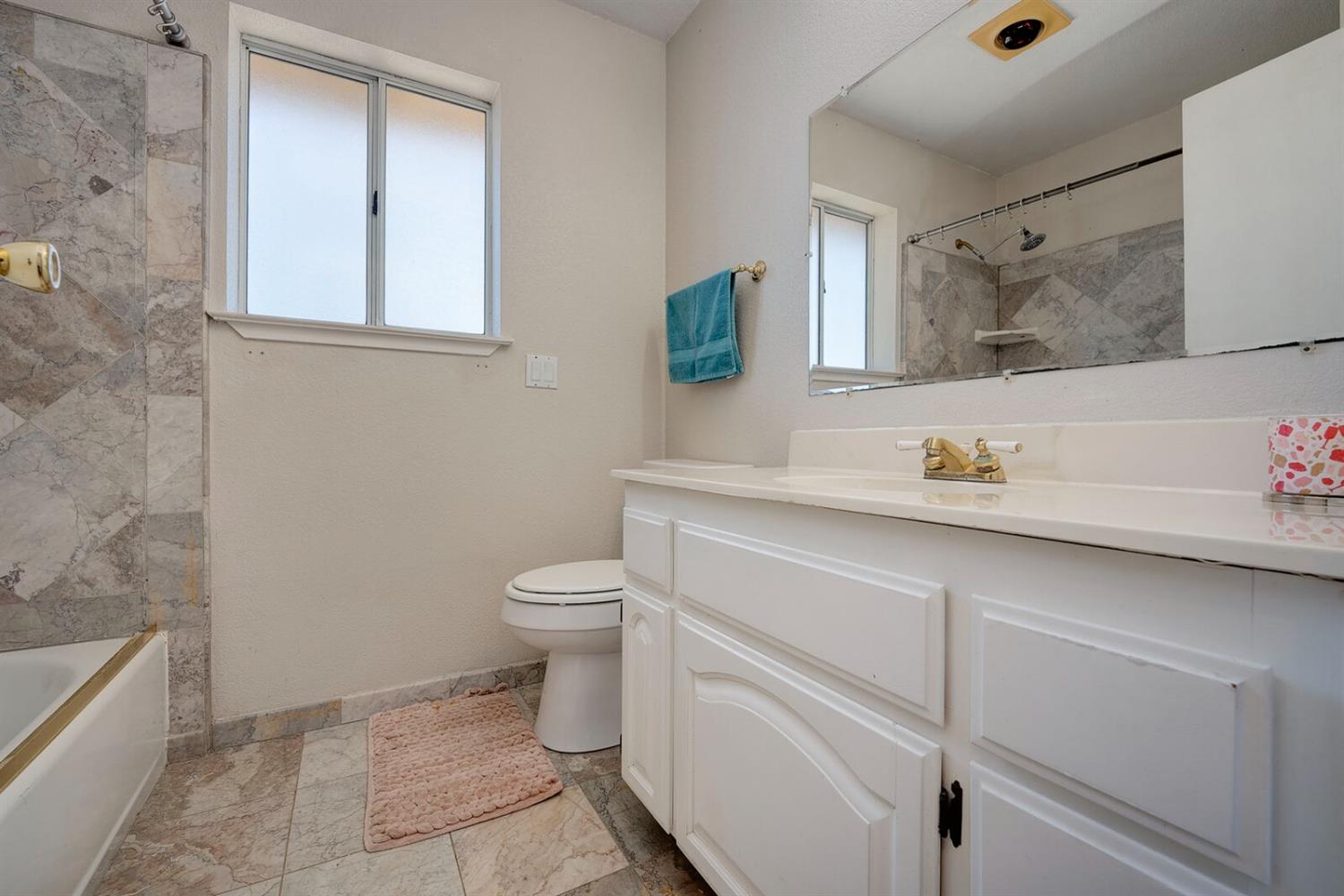 4427 East Catlett Road Lincoln, CA 95648 - Photo 29 of 51 a bathroom with a sink a toilet and mirror