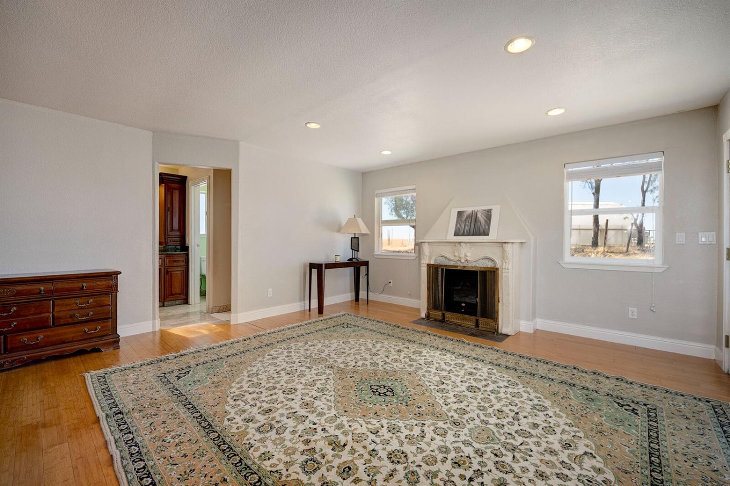 4427 East Catlett Road Lincoln, CA 95648 - Photo 31 of 51 a view of a livingroom with a fireplace cabinet and windows