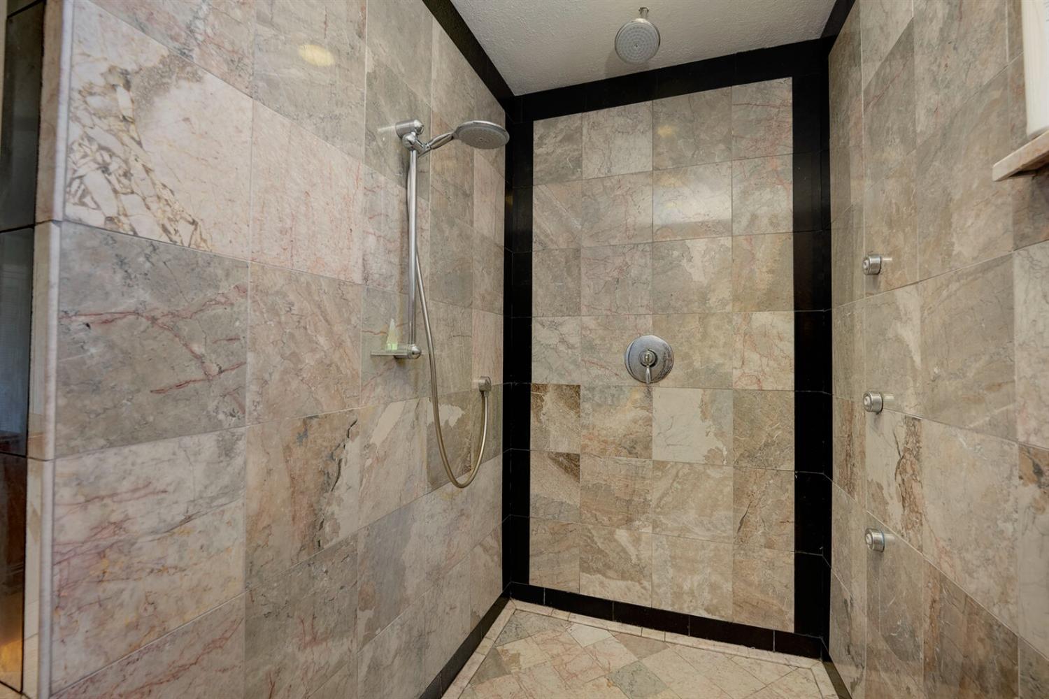 4427 East Catlett Road Lincoln, CA 95648 - Photo 34 of 51 a bathroom with a glass shower door