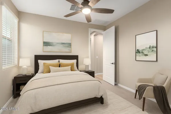 a view of a room with a ceiling fan and window