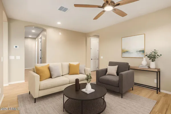 a living room with furniture and a chandelier