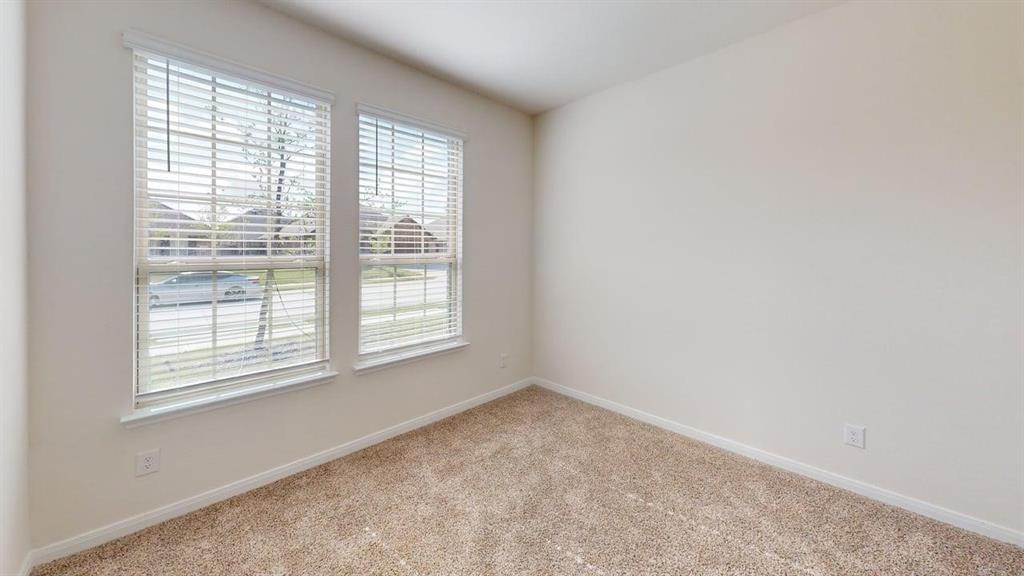 1306 Colonial Bluff Lane Princeton, TX 75407 - Photo 16 of 27 Bright room featuring twin windows with horizontal blinds, neutral wall paint, and textured carpeting