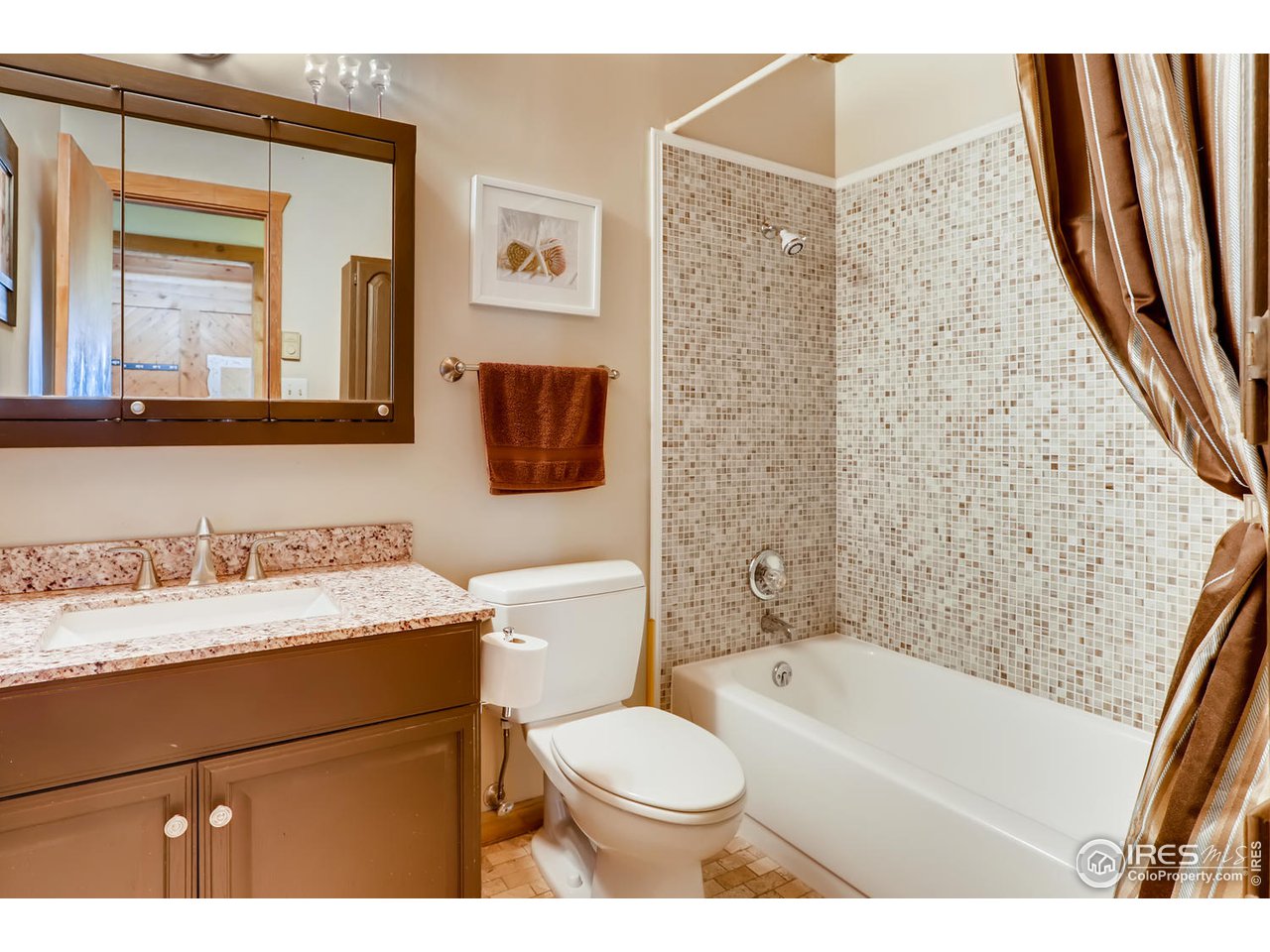 11840 Wasatch Road Longmont, CO 80504 - Photo 18 of 38 a bathroom with a granite countertop sink toilet mirror vanity and bathtub