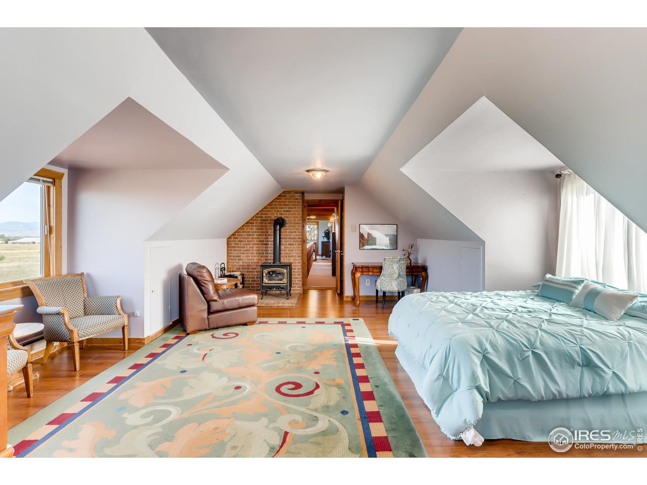 11840 Wasatch Road Longmont, CO 80504 - Photo 20 of 38 a bedroom with a bed and a large window