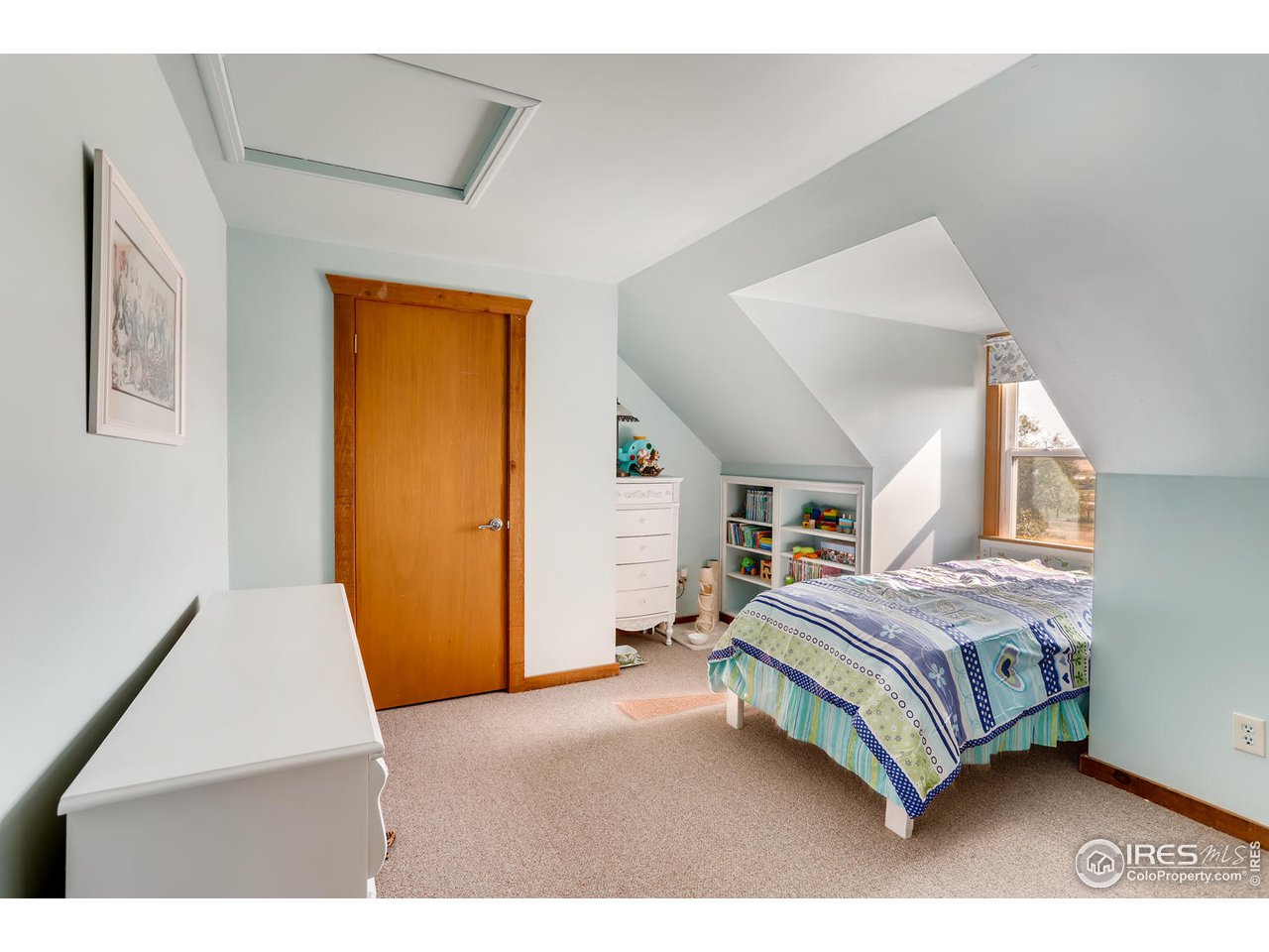 11840 Wasatch Road Longmont, CO 80504 - Photo 23 of 38 a bedroom with a bed and a mirror