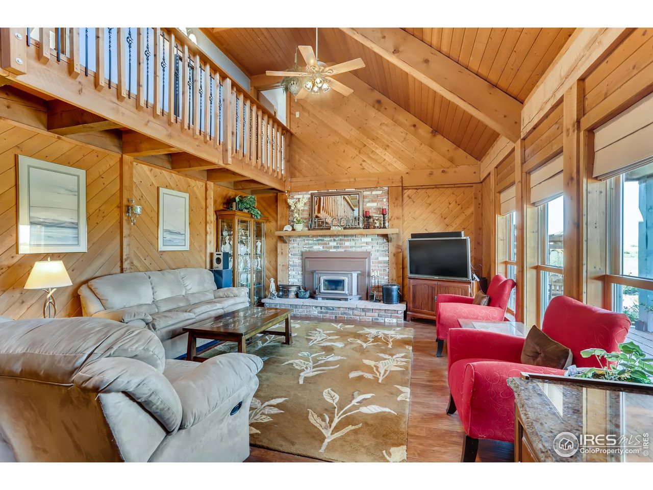 11840 Wasatch Road Longmont, CO 80504 - Photo 6 of 38 a living room with furniture a flat screen tv and a fireplace