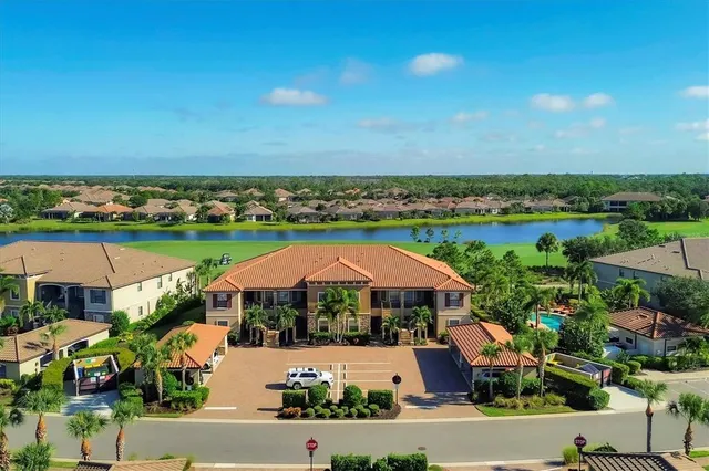 an aerial view of a house with a garden and lake view
