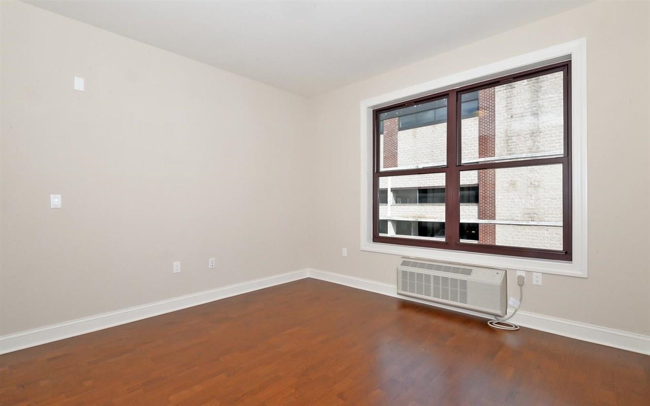 100 Marshall Street, Unit 215 Hoboken, NJ 07030 - Photo 4 of 15 a view of an empty room with a window