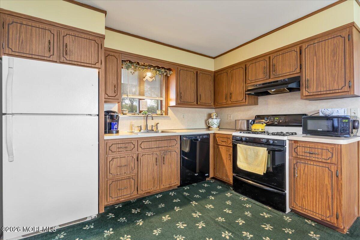 225 Freeman Street Woodbridge, NJ 07095 - Photo 11 of 39 a kitchen with sink cabinets and window