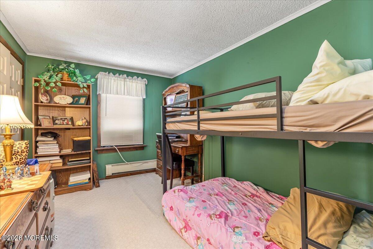 225 Freeman Street Woodbridge, NJ 07095 - Photo 16 of 39 a bedroom with a bed and a window