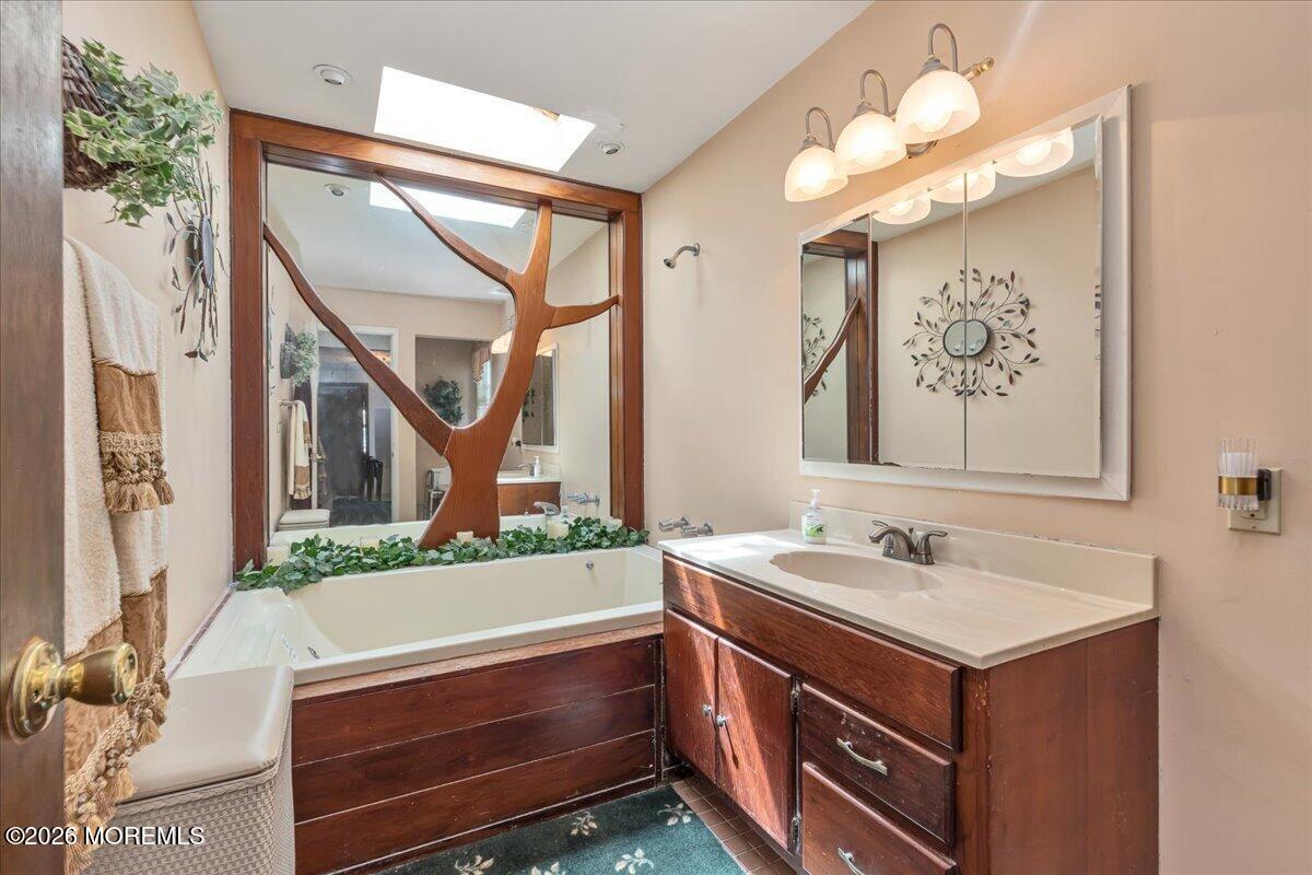 225 Freeman Street Woodbridge, NJ 07095 - Photo 19 of 39 a bathroom with a sink vanity and a mirror