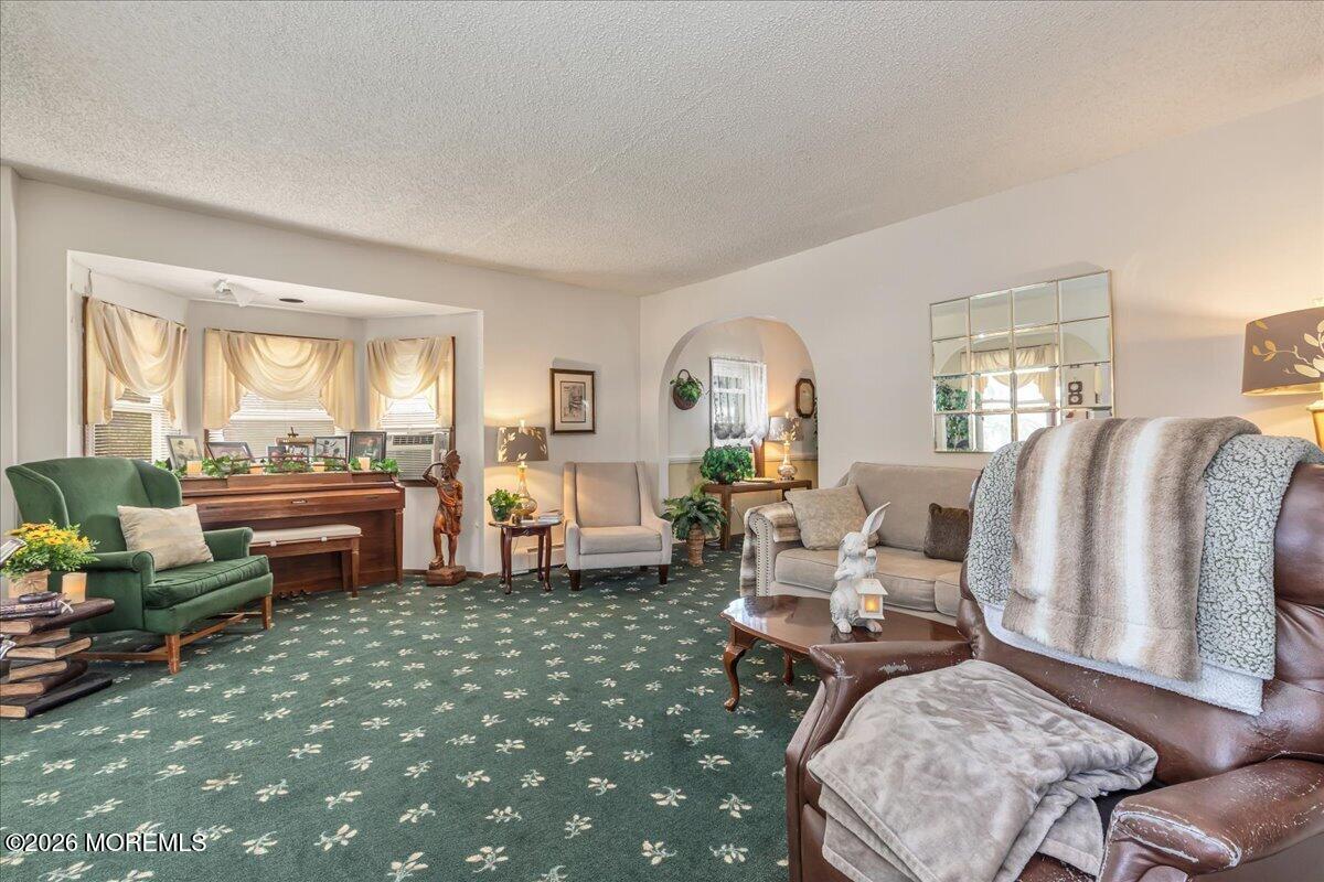 225 Freeman Street Woodbridge, NJ 07095 - Photo 2 of 39 a living room with furniture a fireplace and large windows