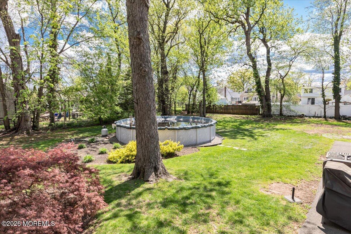225 Freeman Street Woodbridge, NJ 07095 - Photo 33 of 39 a view of a garden with large trees