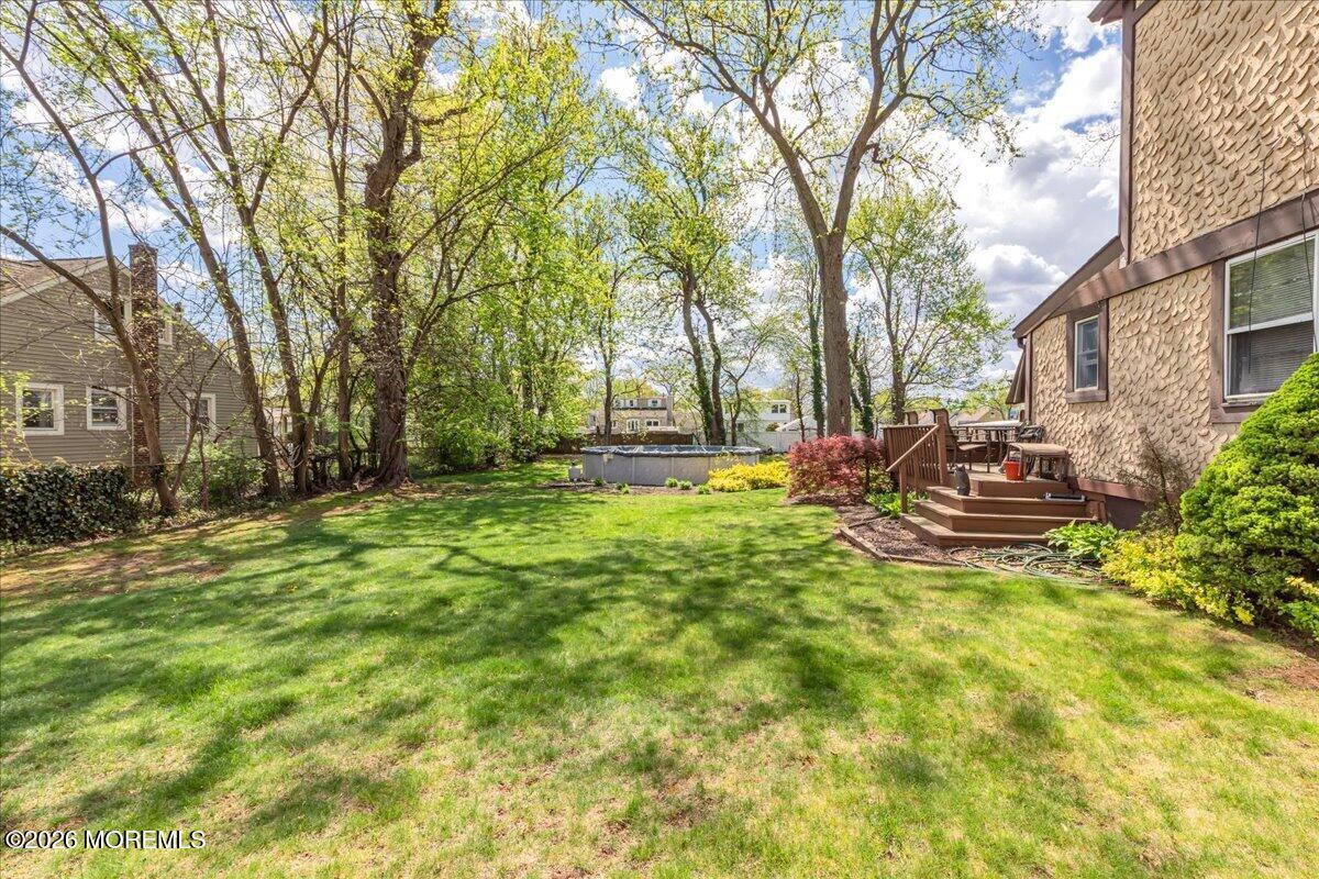 225 Freeman Street Woodbridge, NJ 07095 - Photo 37 of 39 a view of backyard with swimming pool and green space