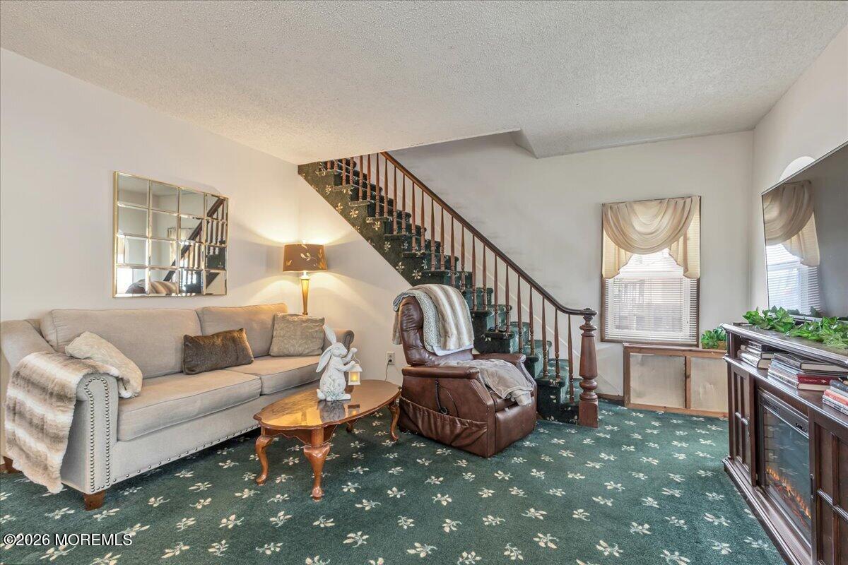 225 Freeman Street Woodbridge, NJ 07095 - Photo 4 of 39 a living room with furniture and a table