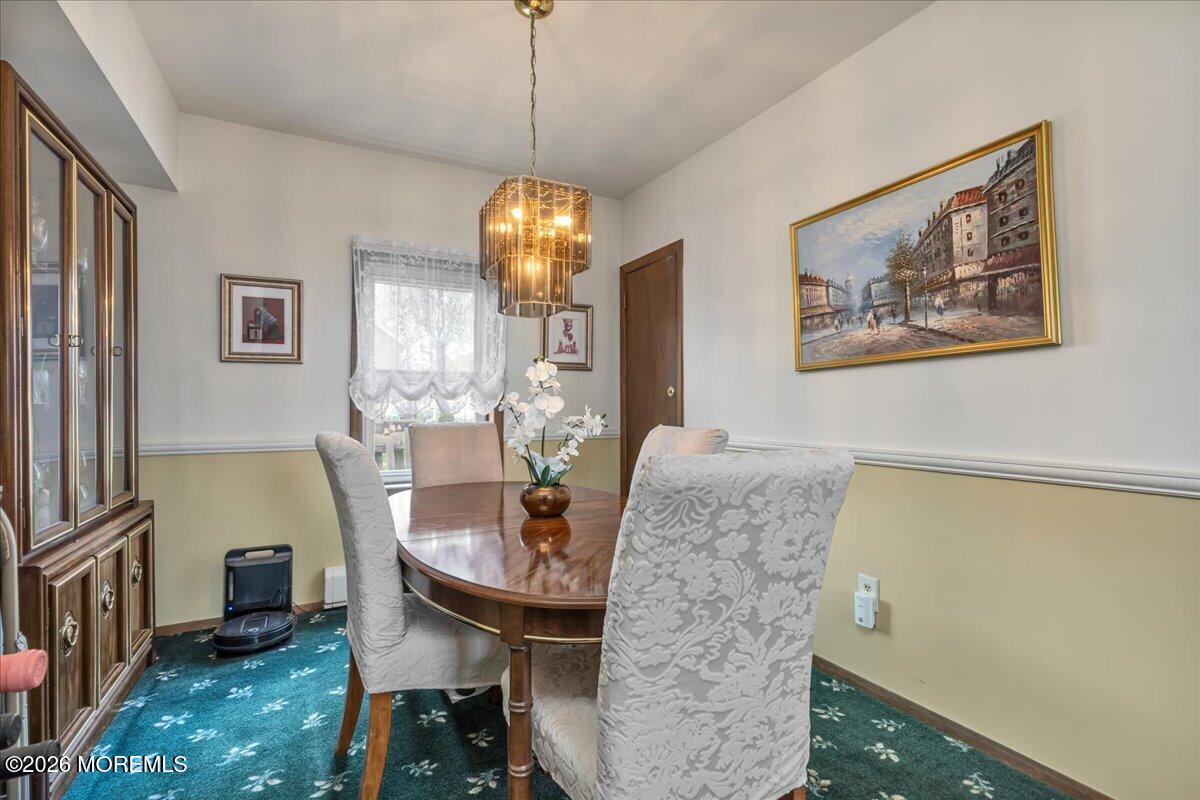 225 Freeman Street Woodbridge, NJ 07095 - Photo 8 of 39 a view of a dining room with furniture wooden floor and chandelier