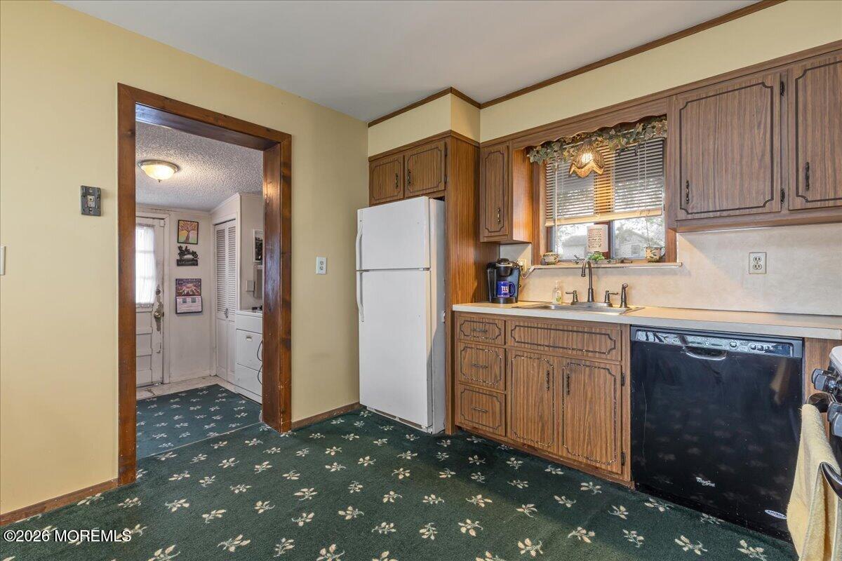 225 Freeman Street Woodbridge, NJ 07095 - Photo 10 of 39 a kitchen with a refrigerator sink and cabinets
