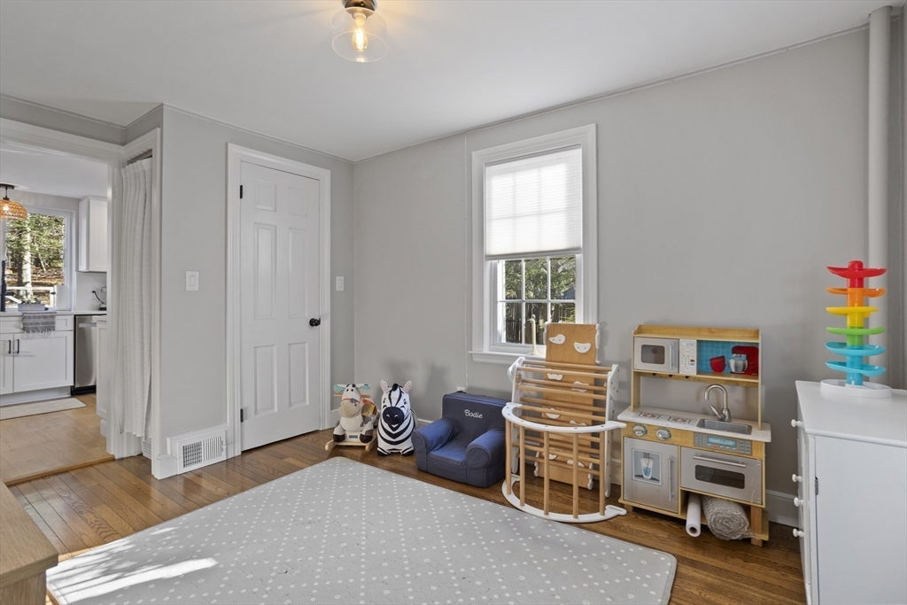 85 Red Acre Road Stow, MA 01775 - Photo 23 of 36 a room with furniture a baby crib and a window