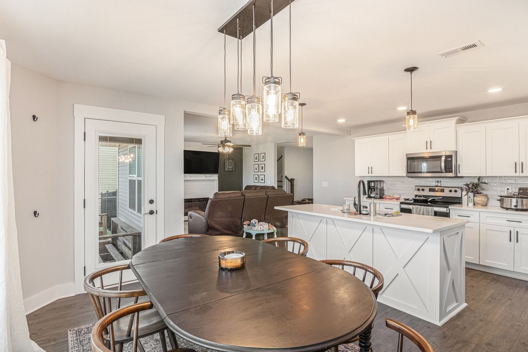 786 Limestone Way Clarksville, TN 37043 - Photo 13 of 29 a kitchen with stainless steel appliances kitchen island granite countertop a sink a stove a dining table and chairs