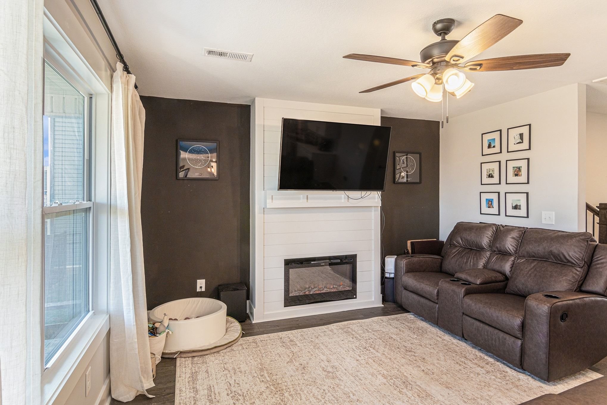 786 Limestone Way Clarksville, TN 37043 - Photo 2 of 29 a living room with furniture a flat screen tv and a fireplace