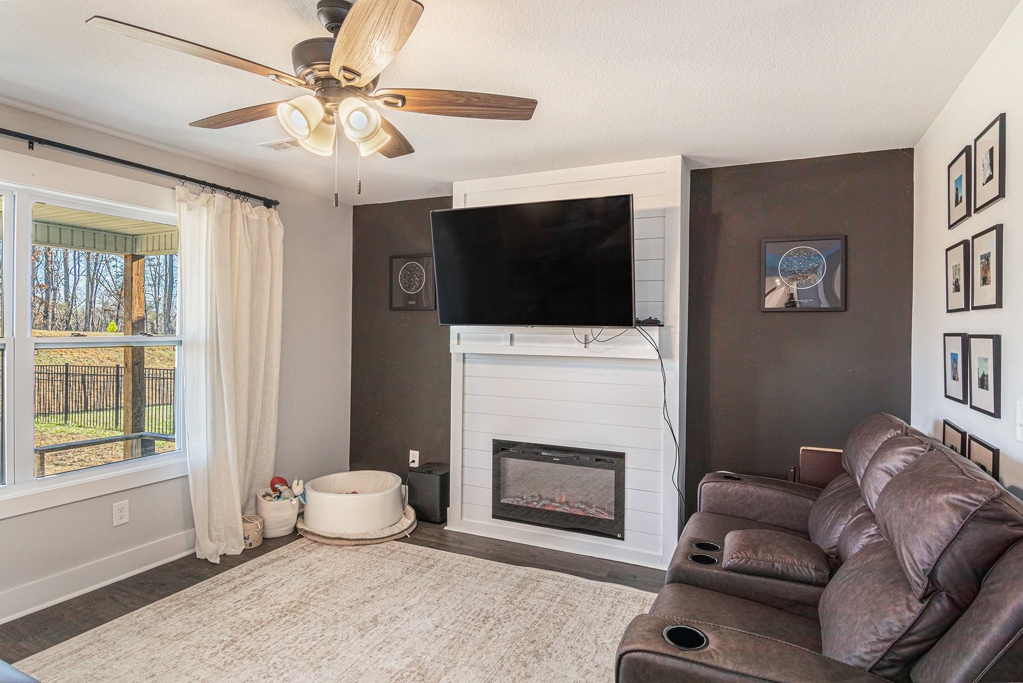 786 Limestone Way Clarksville, TN 37043 - Photo 3 of 29 a living room with furniture a flat screen tv and a fireplace