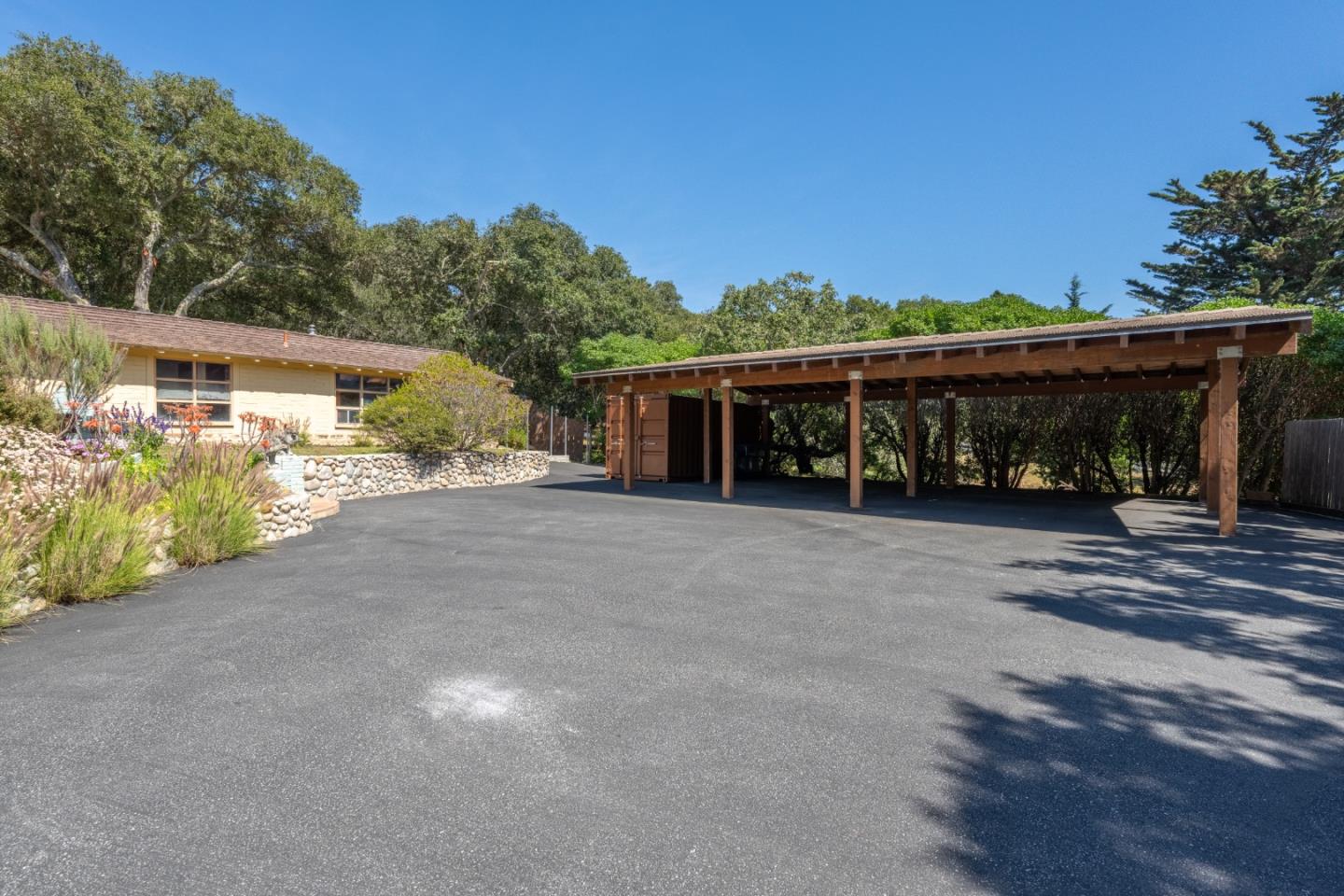 72 Los Laureles Grade Road Carmel Valley, CA 93924 - Photo 30 of 43 a view of a house with a yard and potted plants