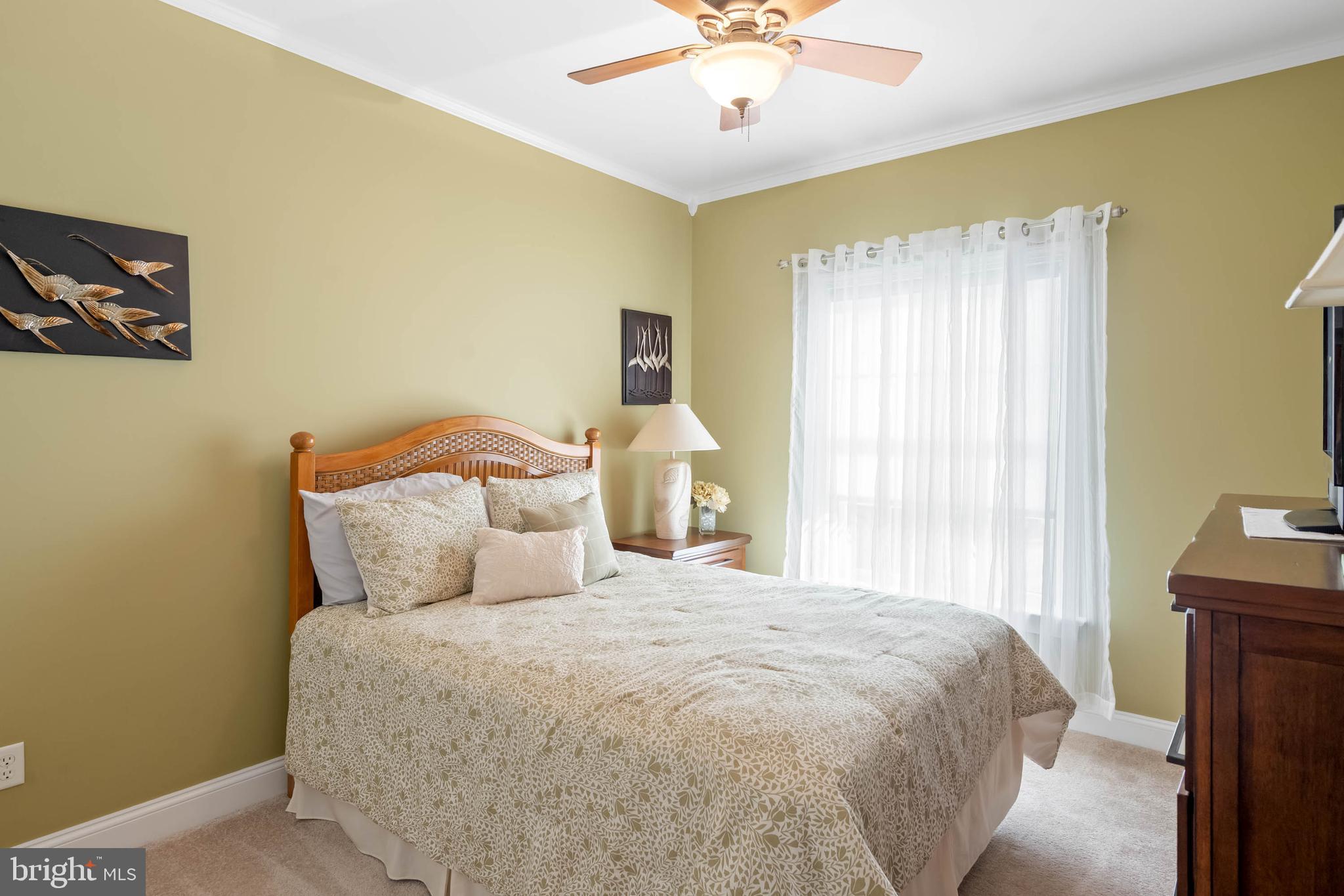28344 River Road Seaford, DE 19973 - Photo 24 of 62 a bedroom with a bed and a chandelier