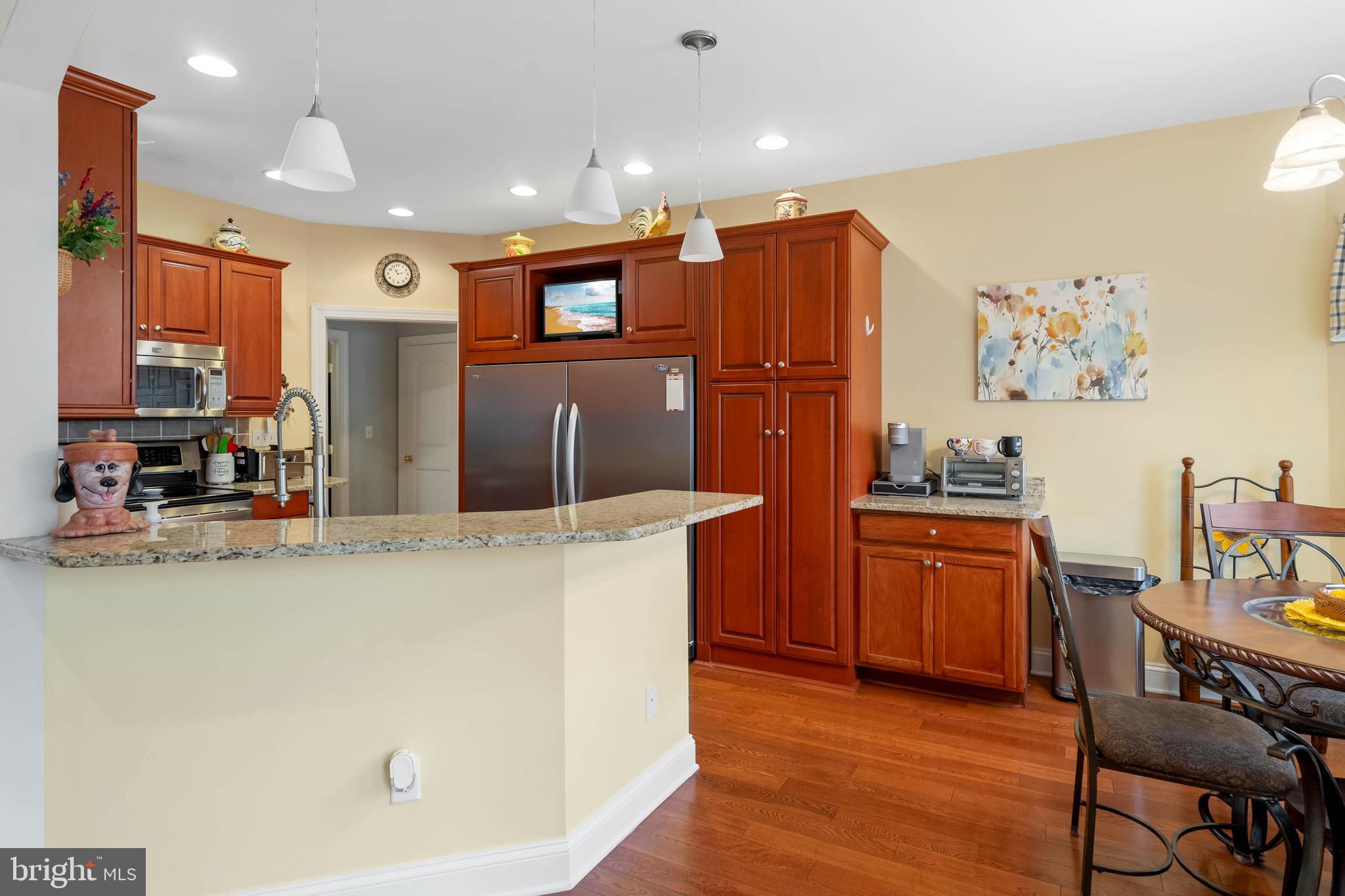28344 River Road Seaford, DE 19973 - Photo 3 of 62 a kitchen with stainless steel appliances granite countertop a refrigerator a stove top oven a sink dishwasher and wooden floor