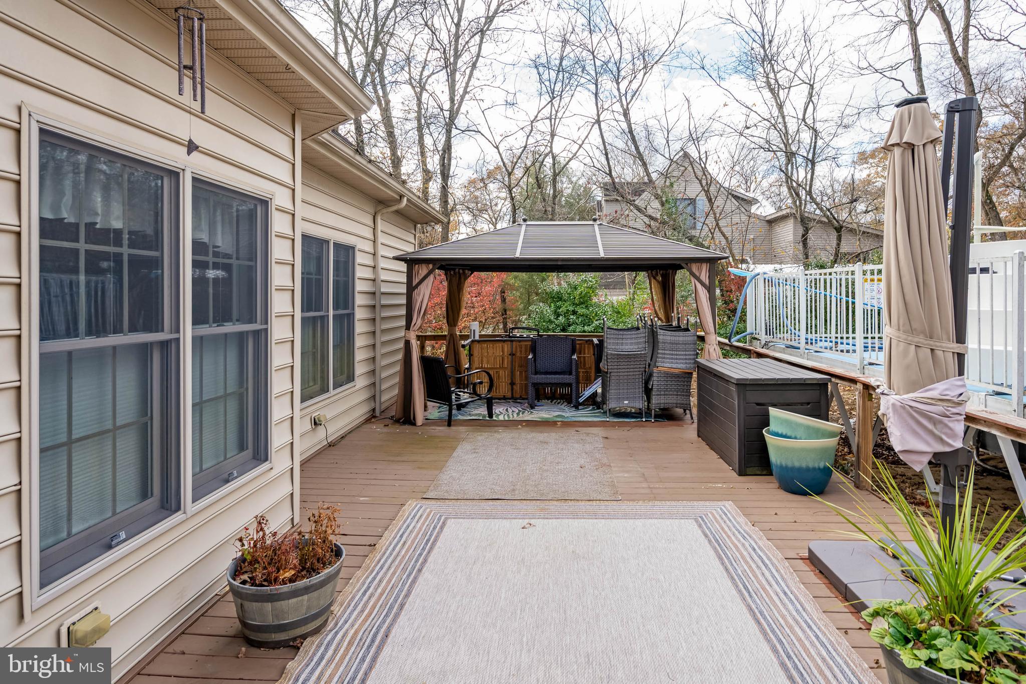 28344 River Road Seaford, DE 19973 - Photo 53 of 62 a view of a patio with table and chairs potted plants and large tree
