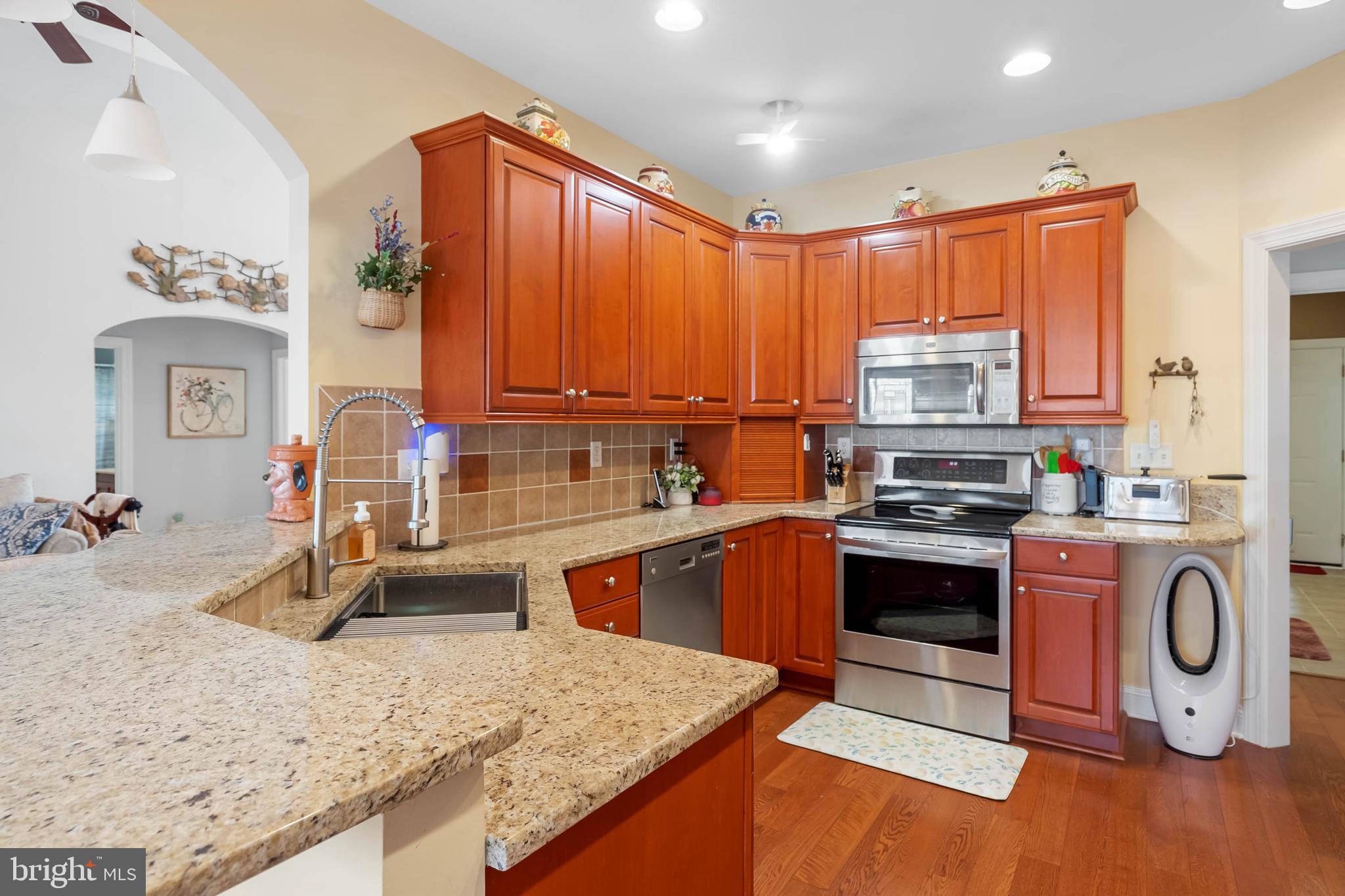28344 River Road Seaford, DE 19973 - Photo 6 of 62 a kitchen with stainless steel appliances granite countertop a sink stove and refrigerator