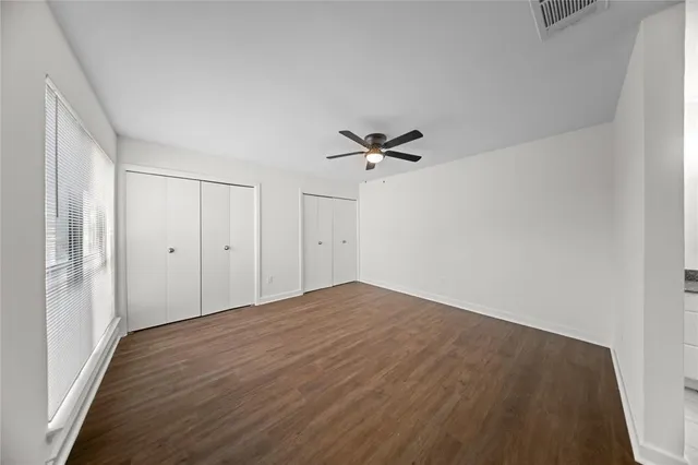 a view of empty room with a fan
