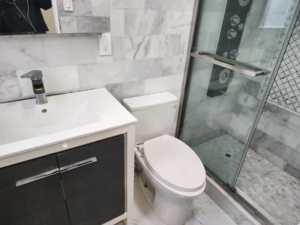 a white toilet sitting next to a bathroom sink