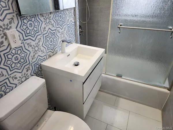a bathroom with a sink and toilet