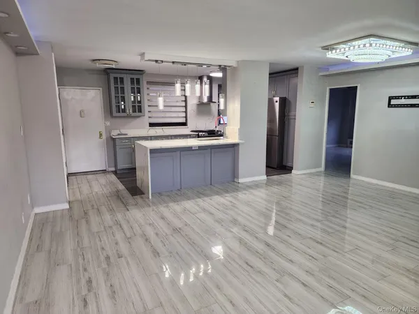 a open kitchen with stainless steel appliances granite countertop a refrigerator and a stove top oven