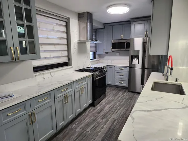 a kitchen with a sink stove and refrigerator