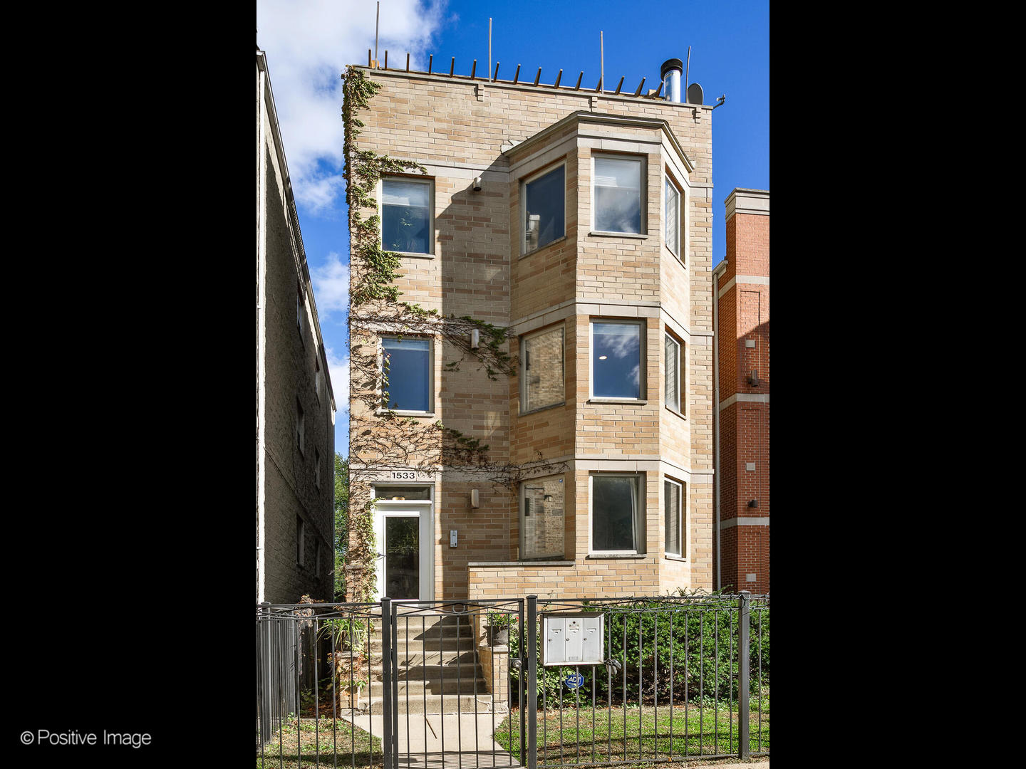 1533 North Campbell Avenue, Unit 2 Chicago, IL 60622 - Photo 1 of 14 a front view of a house with a yard