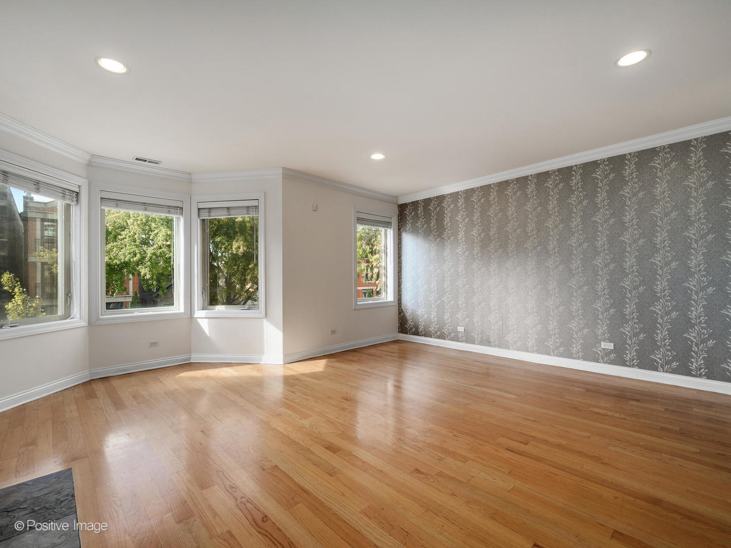 1533 North Campbell Avenue, Unit 2 Chicago, IL 60622 - Photo 4 of 14 a view of an empty room with wooden floor and a window