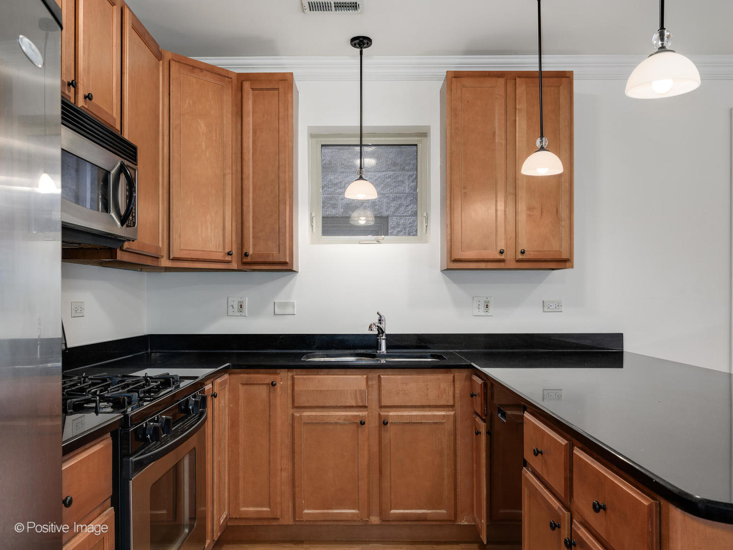 1533 North Campbell Avenue, Unit 2 Chicago, IL 60622 - Photo 8 of 14 a kitchen with stainless steel appliances granite countertop a stove a sink and a microwave