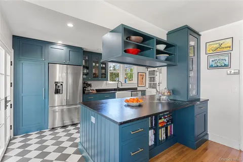 a kitchen with stainless steel appliances granite countertop a refrigerator and a sink