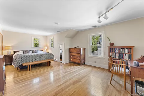 a bedroom with furniture and a book shelf