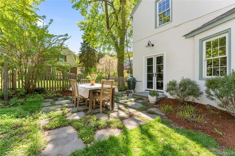 a view of a house with backyard sitting area and garden