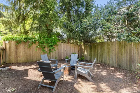 a view of a backyard with chairs