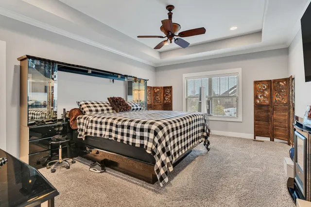 a bedroom with a bed a window and walk in closet