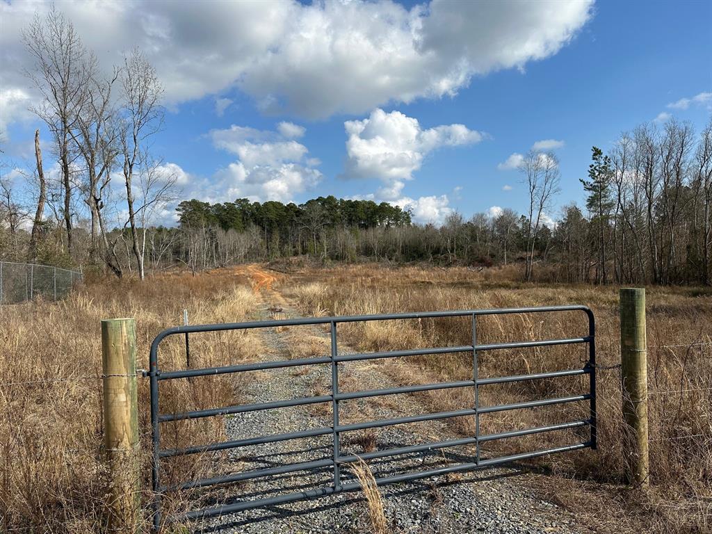 102 Ryan's Way Minden, LA 71055 - Photo 4 of 11 a view of a green field with wooden fence