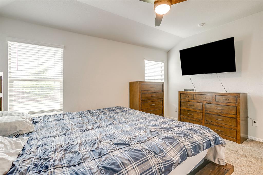 2313 Stallings Road Fort Worth, TX 76108 - Photo 17 of 30 a bedroom with a bed and a flat screen tv