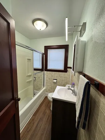 a bathroom with a sink a mirror and a bathtub