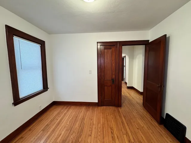 a view of hallway with wooden floor