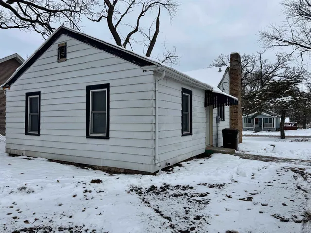 a view of a backyard with a large tree