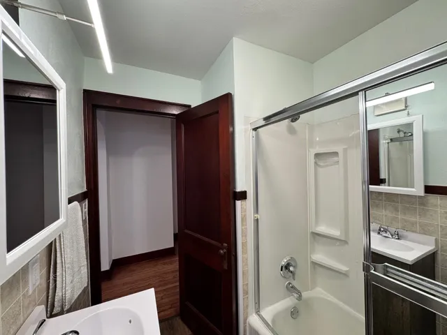 a bathroom with a bathtub and a shower